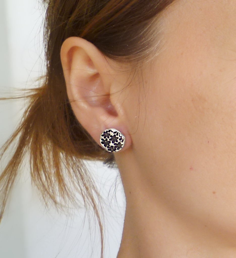 Sterling silver floral print stud earrings.