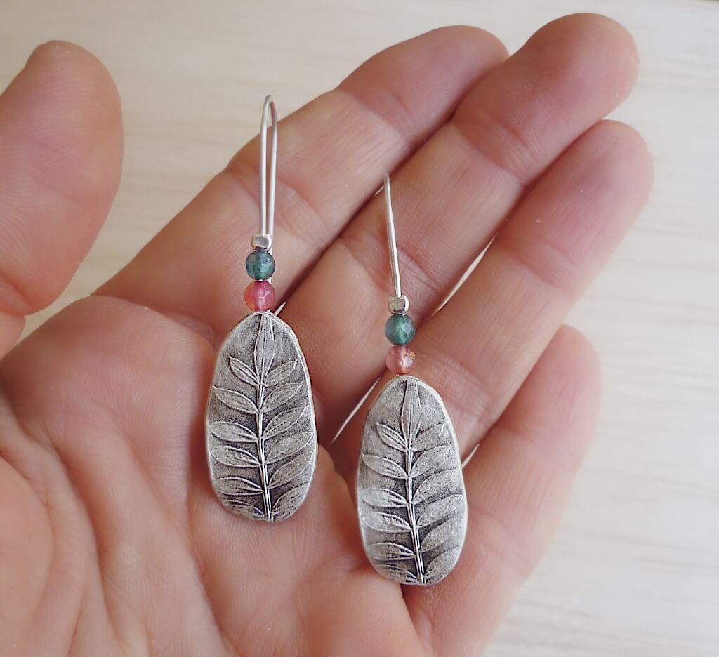 The jacaranda leaf earrings are back! This time they are adorned with faceted jade gemstones.