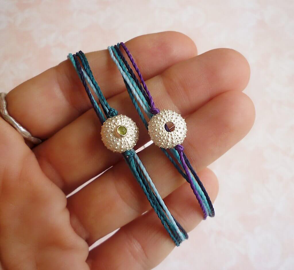 Sea urchin bracelets with multicolour cords.