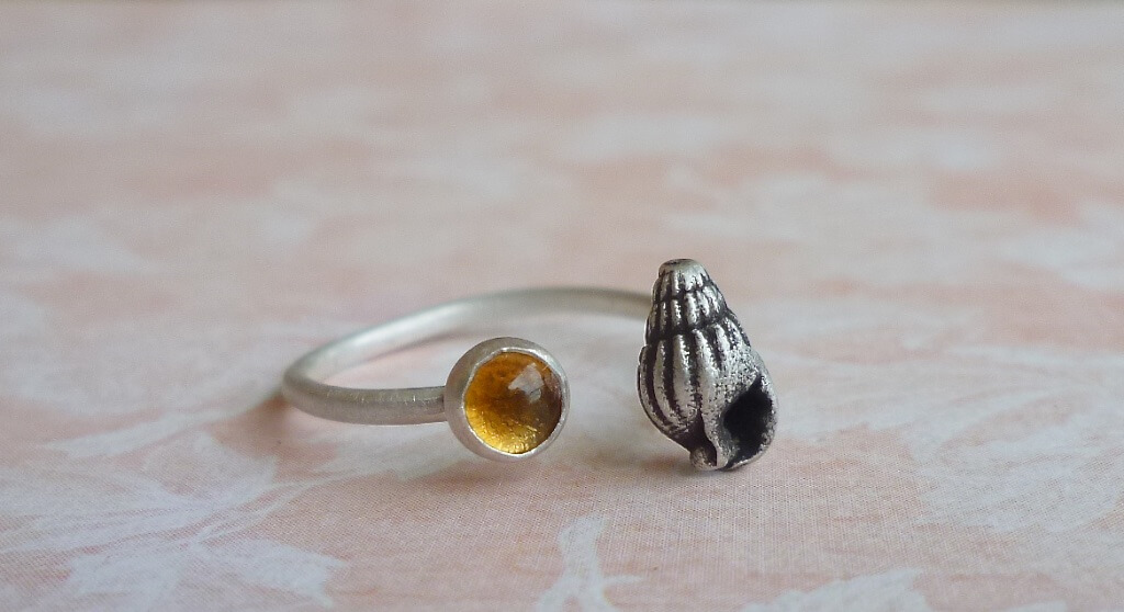 This seashell silver ring is adjustable. I chose citrine to represent the sun in jusxtaposition with the sea. But I'm also going to try combining the seashell with different gemstones. 