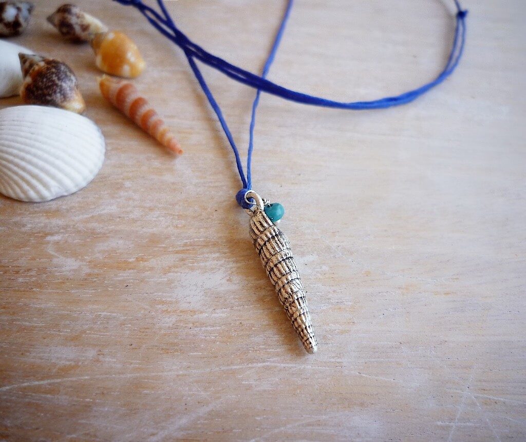 The silver seashell pendant with a tiny turquoise rondelle just added.