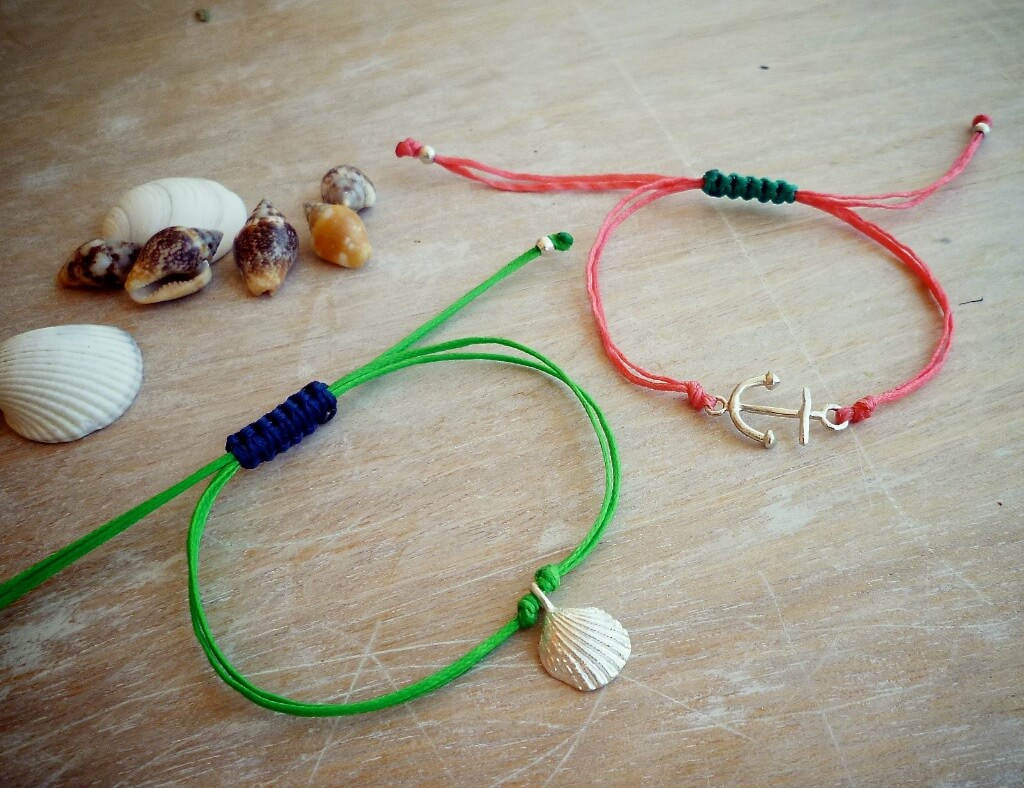 Seashell and anchor bracelets, each with an adjustable closure.